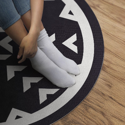 Pvc mat rond Wit pijlenpatroon op een donkere achtergrond