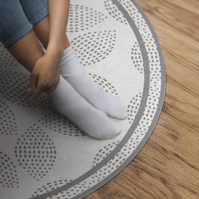 Vinyl vloerkleed rond Een compositie van donkere bladeren met stippen