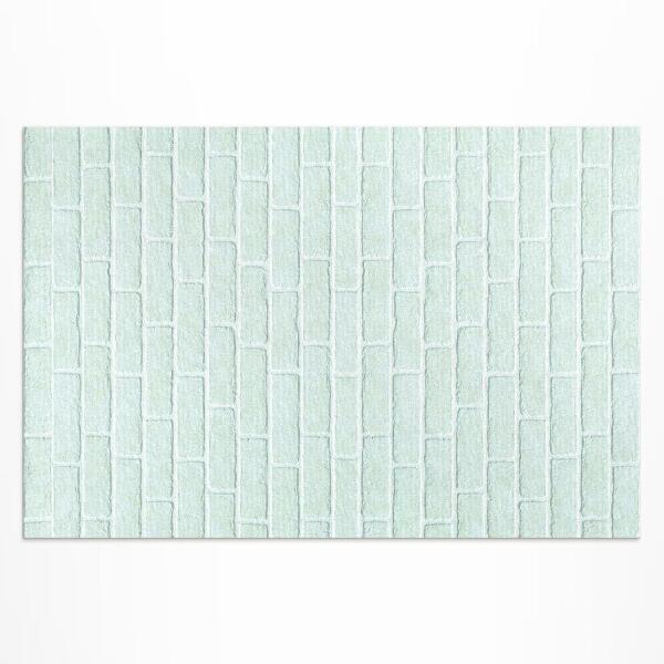 Buiten tapijt Een bakstenen muur in een blauwgroene kleur