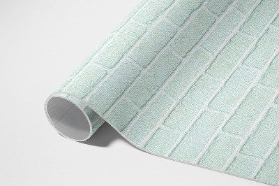 Buiten tapijt Een bakstenen muur in een blauwgroene kleur