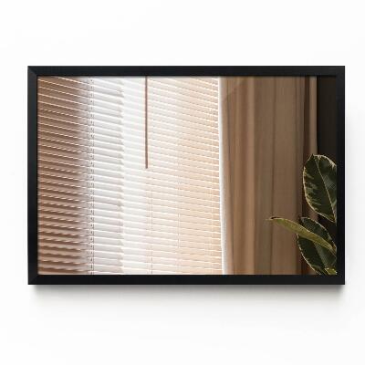 Decoratieve rechthoekige spiegel in een zwarte lijst