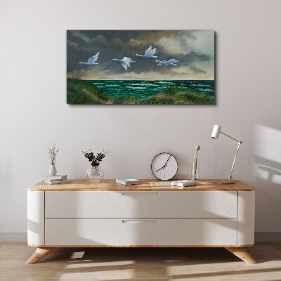 Schilderij op doek Vlucht van zwanen over de zee