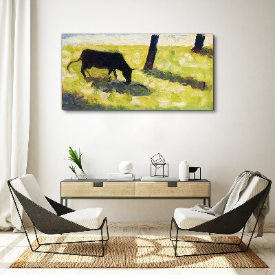 Canvas schilderij Een koe graast in een groen landschap