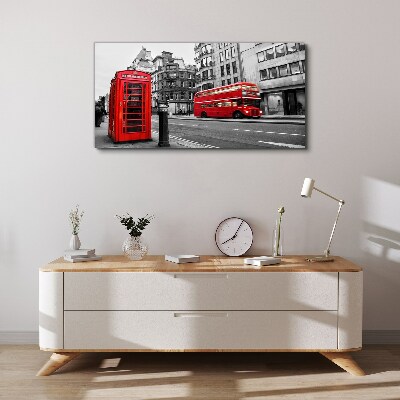 Foto op canvas Een rode telefoon in een grijze stad