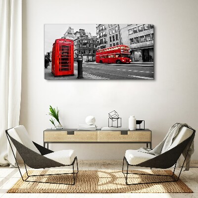 Foto op canvas Een rode telefoon in een grijze stad