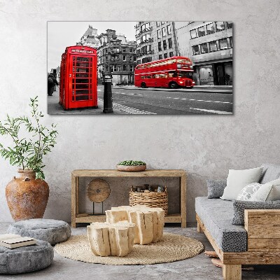 Foto op canvas Een rode telefoon in een grijze stad