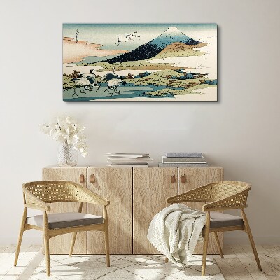 Canvas schilderij Kranen bij een berg