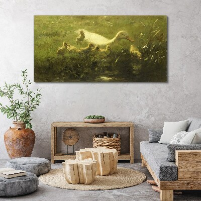 Foto op canvas Een eend met kuikens in het gras