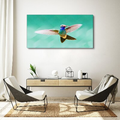 Canvas schilderij Kolibrie op een blauwe achtergrond