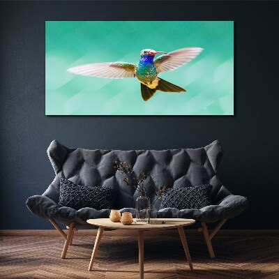 Canvas schilderij Kolibrie op een blauwe achtergrond