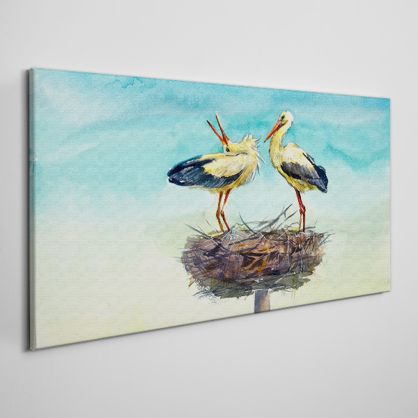 Canvas schilderij Ooievaars op een nest in het blauw