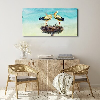 Canvas schilderij Ooievaars op een nest in het blauw