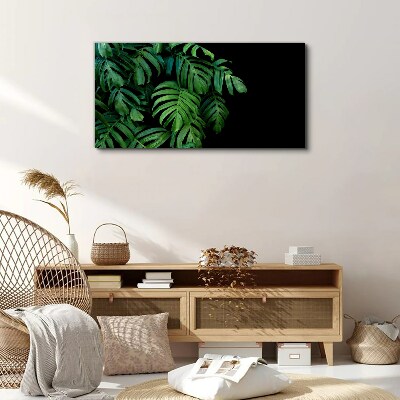 Canvas schilderij Groene bladeren op een zwarte achtergrond