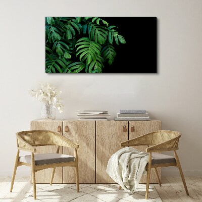 Canvas schilderij Groene bladeren op een zwarte achtergrond