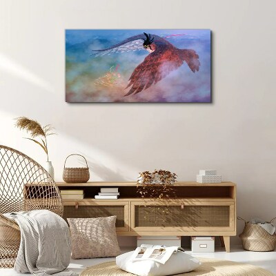 Schilderij op doek Vlucht van een roofvogel in de wolken