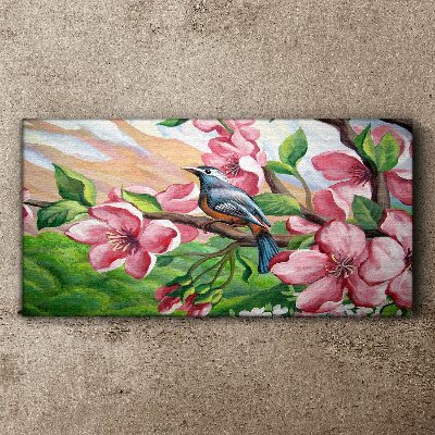 Canvas schilderij Een vogel tegen een achtergrond van lentebloemen
