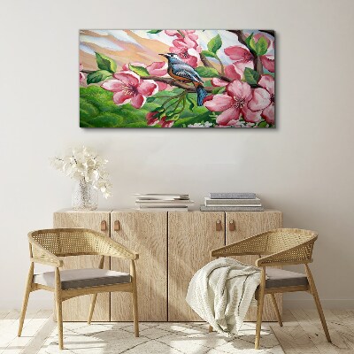 Canvas schilderij Een vogel tegen een achtergrond van lentebloemen