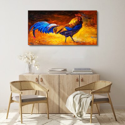 Canvas schilderij Een kleurrijke haan tegen de achtergrond van vuur