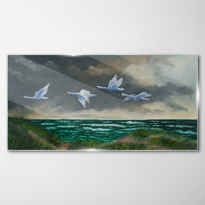 Schilderij op glas Vlucht van zwanen over de zee