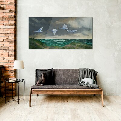 Schilderij op glas Vlucht van zwanen over de zee