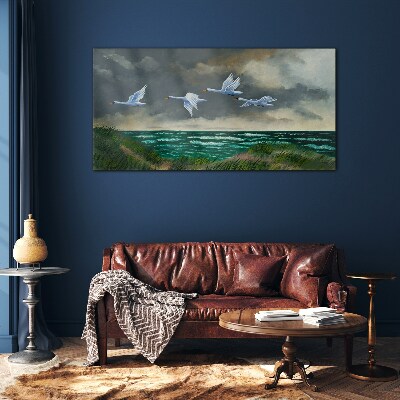 Schilderij op glas Vlucht van zwanen over de zee