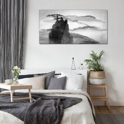 Foto op glas Een eenzame boom op een rotsachtige berg