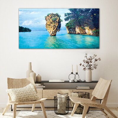 Foto op glas Een kalme baai met een hoge rots