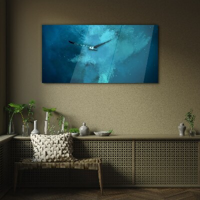 Foto op glas Een vogel in de blauwe ruimte