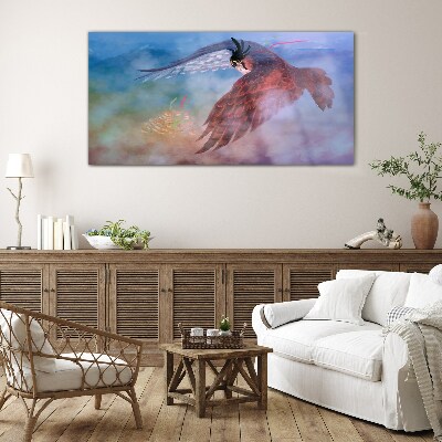 Schilderij op glas Vlucht van een roofvogel in de wolken