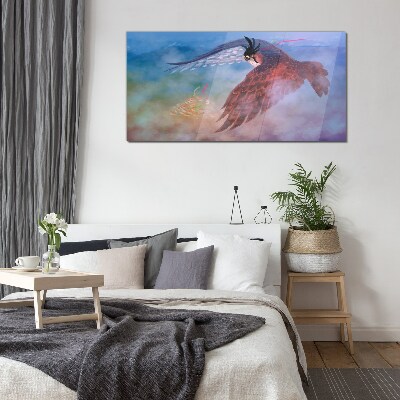 Schilderij op glas Vlucht van een roofvogel in de wolken