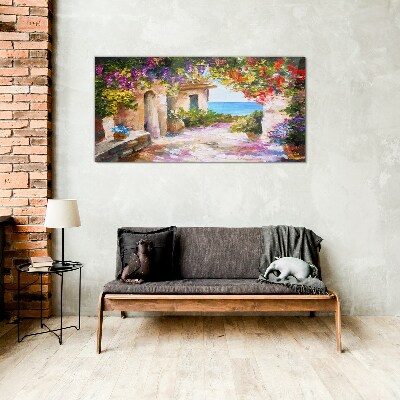 Foto op glas De bloemenlaan van een kustdorp