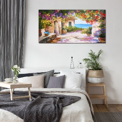 Foto op glas De bloemenlaan van een kustdorp